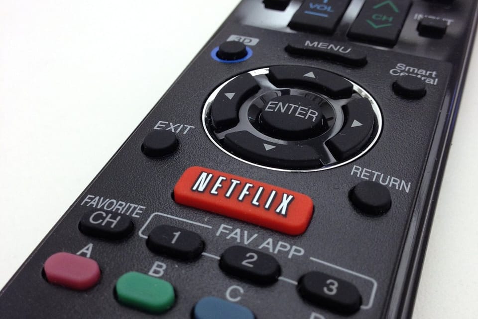 A dedicated Netflix button on a television remote control